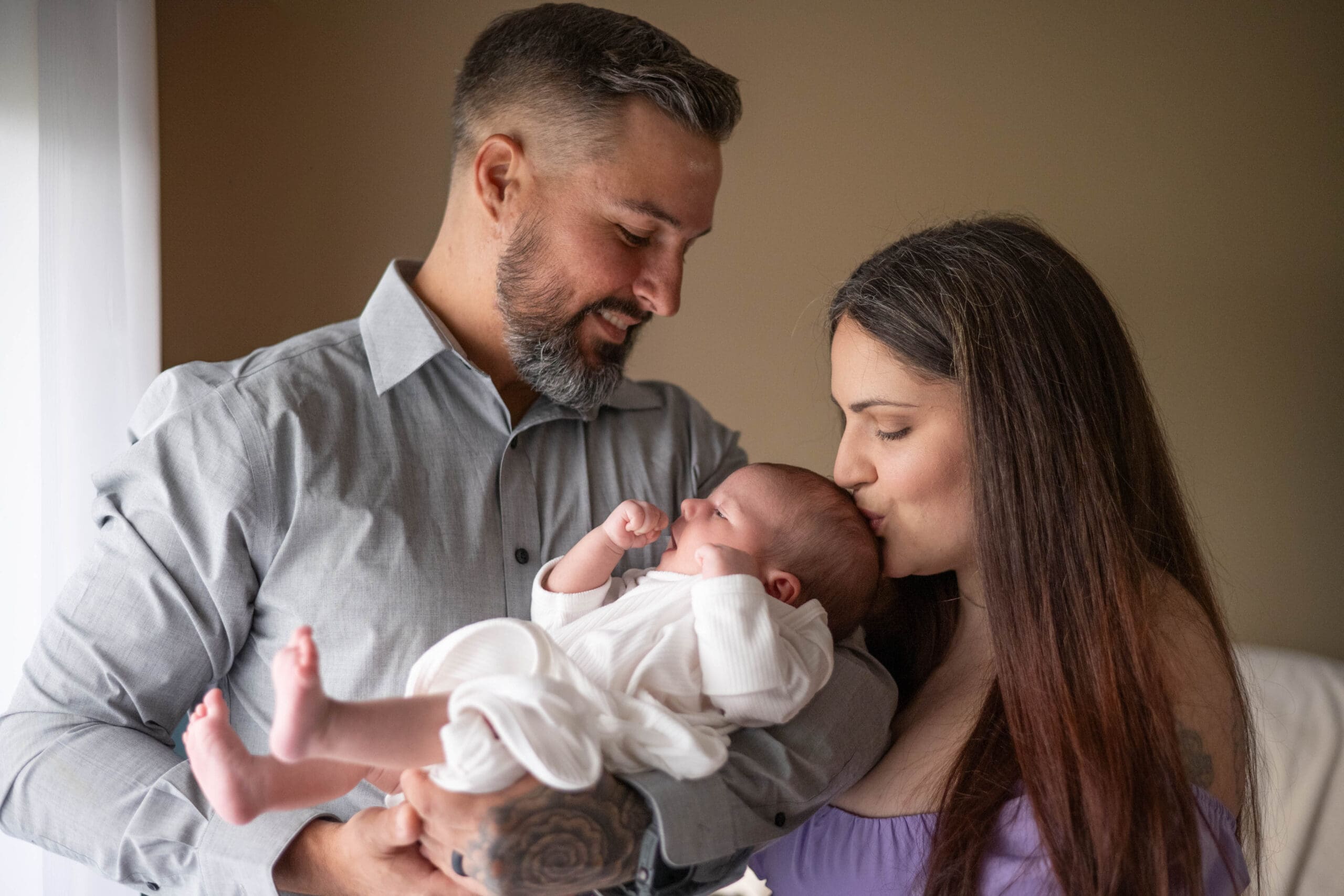 New parents photographed with their newborn with South Louisiana Lifestyle Photographer