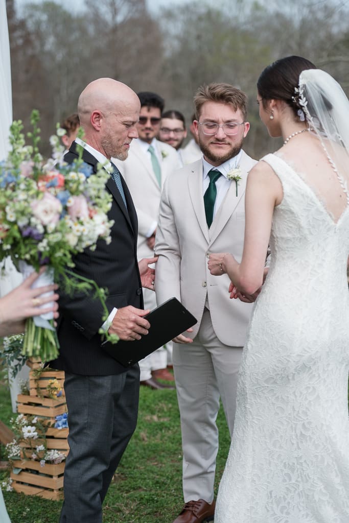 Bride and Groom exchanging rings by South Louisiana Wedding Photographer