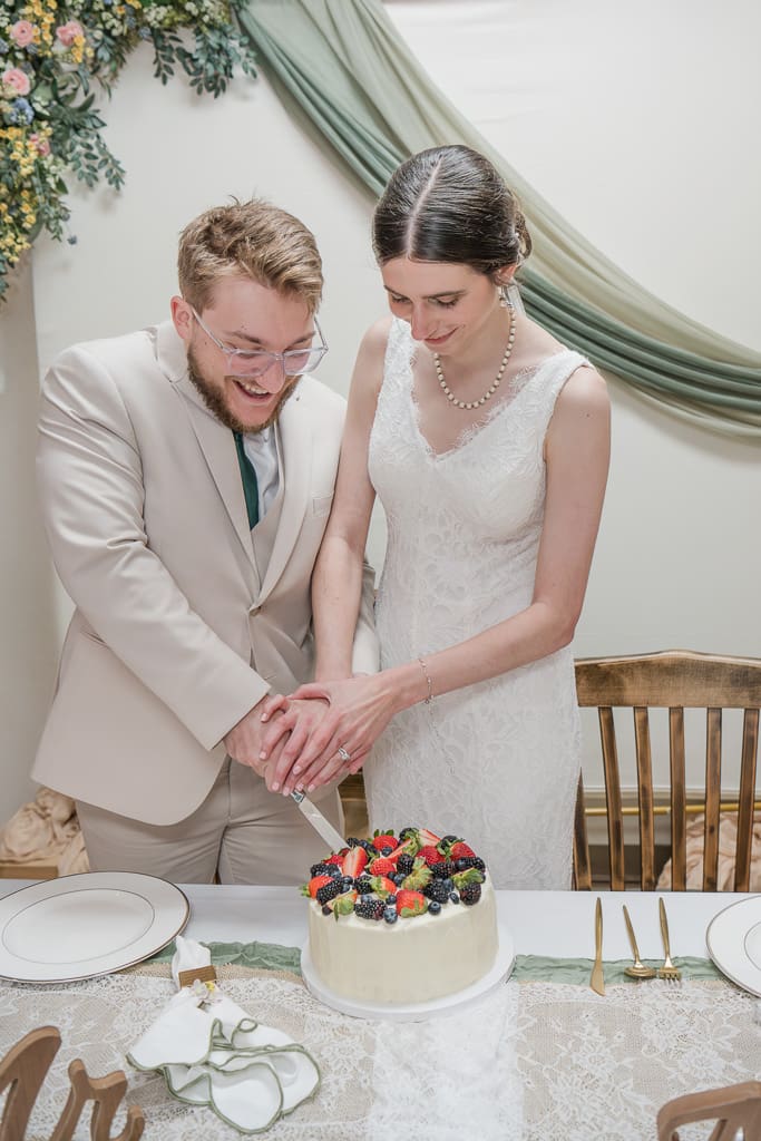 Bride and Groom cutting cake at wedding reception, South Louisiana Wedding Photographer