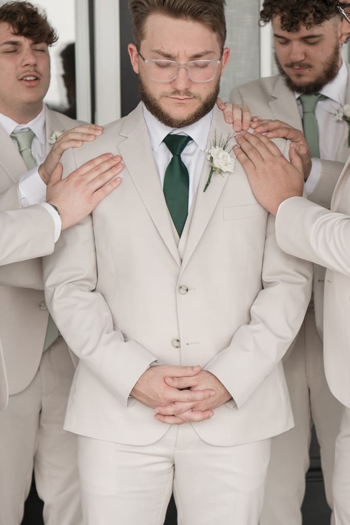 Groomsmen praying over Groom before wedding ceremony in South Louisiana, Acadiana Photographer