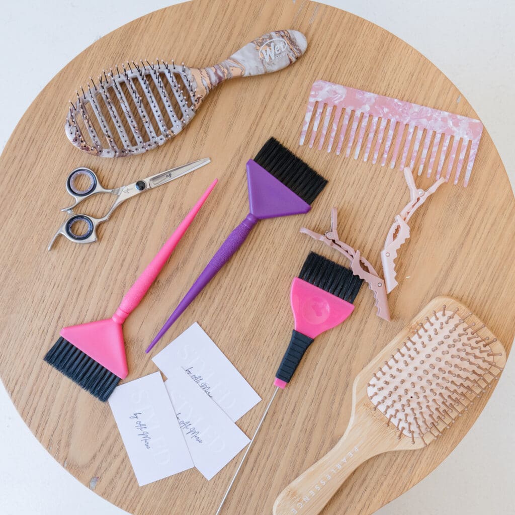 Flat lay arrangement of hair styling tools for local hairstylist brand